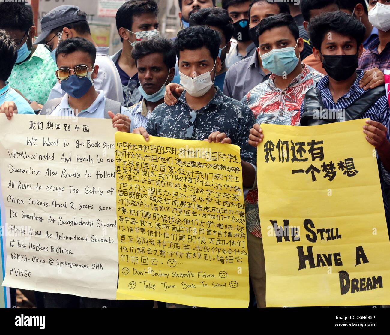 Bangladeshi students of different universities from China, hold placards during a protest, to demand the intervention of the Bangladesh government to can return to China. Students are stranded in Bangladesh unable to return to China, due to the closed borders  by coronavirus pandemic. On September 5, 2021in Dhaka, Bangladesh. (Photo by Habibur Rahman / Eyepix Group) Stock Photo