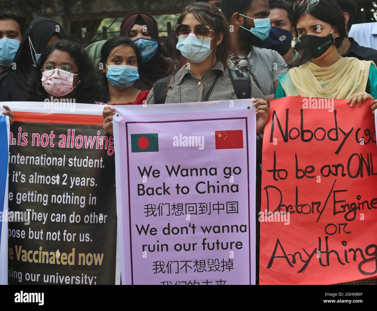 Bangladeshi students of different universities from China, hold placards during a protest, to demand the intervention of the Bangladesh government to can return to China. Students are stranded in Bangladesh unable to return to China, due to the closed borders  by coronavirus pandemic. On September 5, 2021in Dhaka, Bangladesh. (Photo by Habibur Rahman / Eyepix Group) Stock Photo