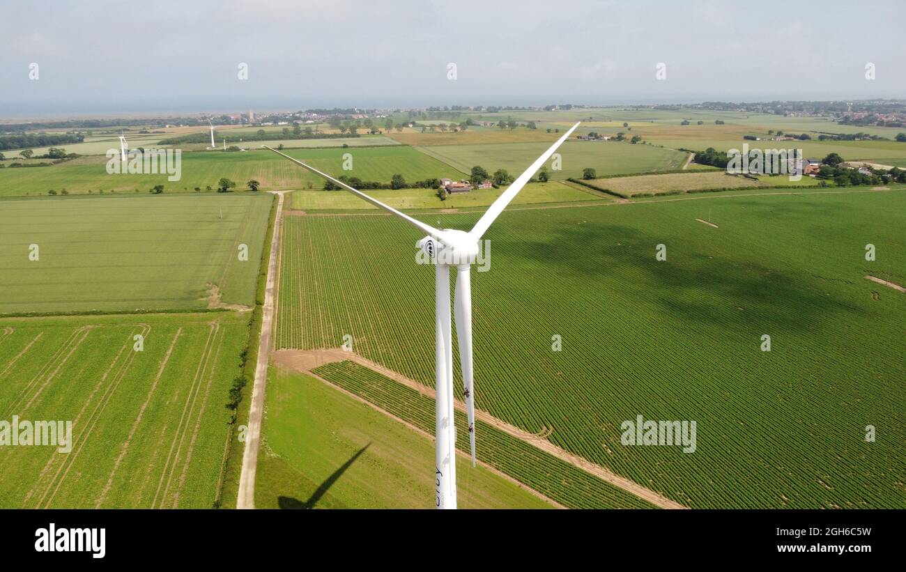 Aerial drone photo of a wind turbine close up in green field Stock Photo