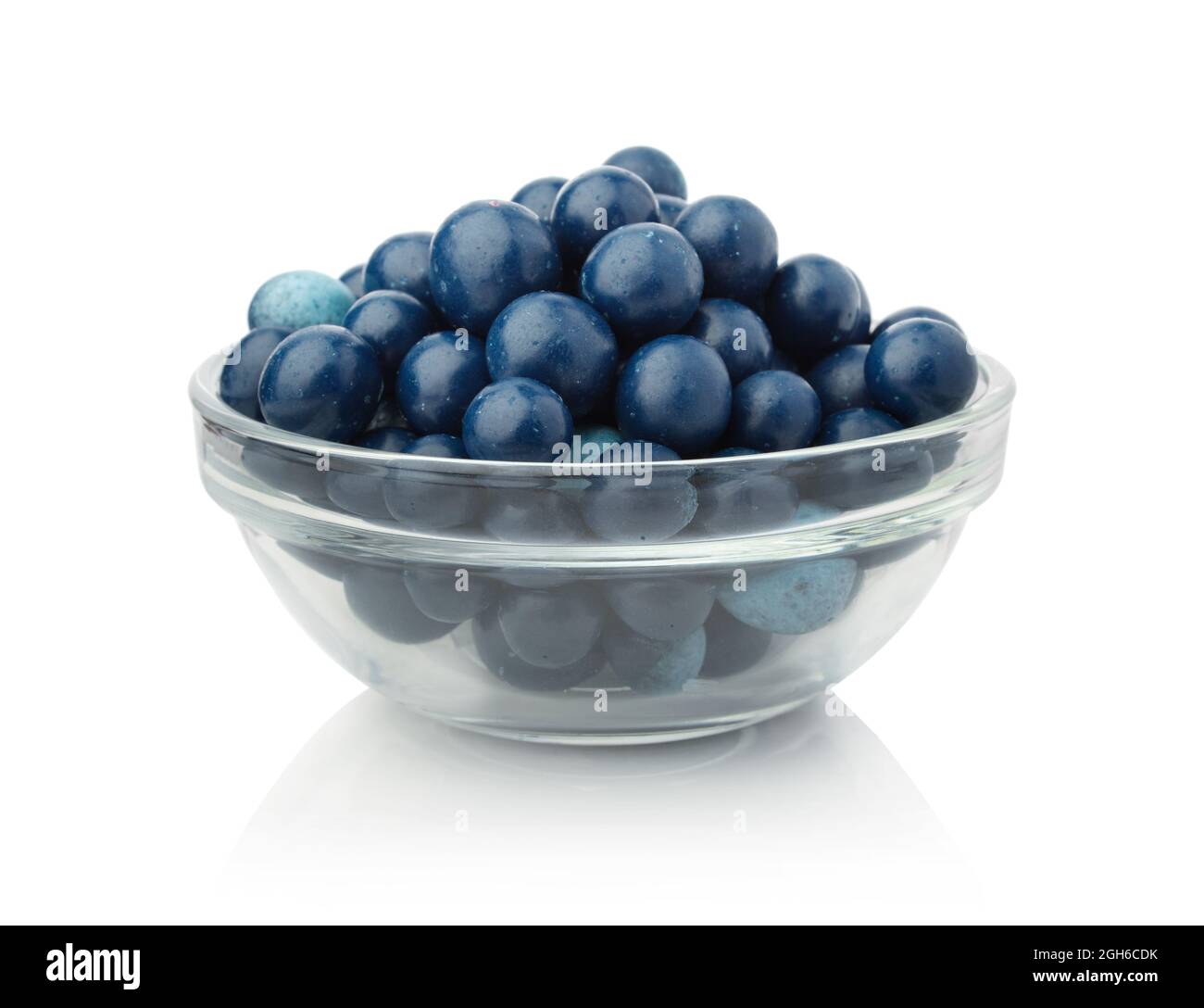 Blueberries covered with yogurt in a glass bowl isolated on white. Stock Photo