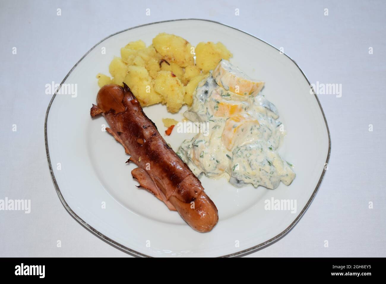 Berner Würstchen with potatoes and zucchini salad Stock Photo