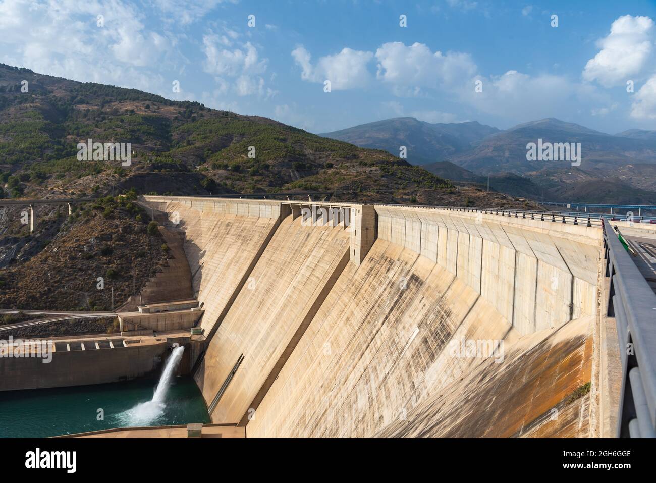 Rules dam in the province of Granada releasing water through one of its