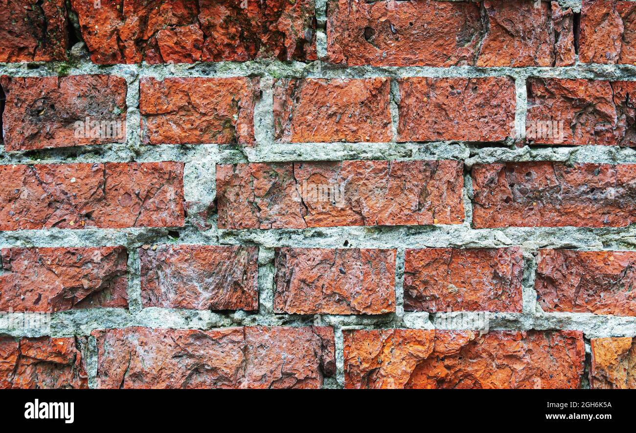Old dilapidated red brick wall. Abstract background, texture, wallpaper. Stock Photo