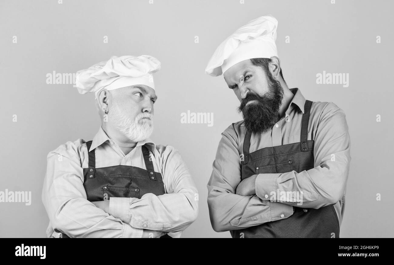 Mature bearded men professional restaurant cooks. Family restaurant