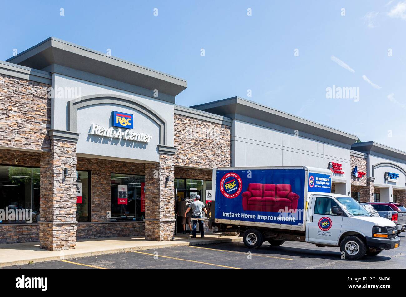 OLEAN, NY, USA14 AUGUST 2021 RentACenter store, showing storefront, delivery truck, two