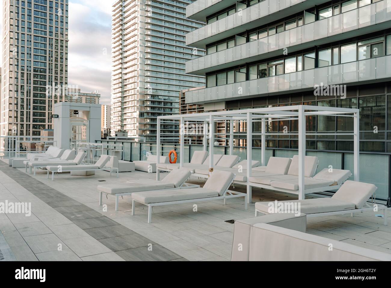 empty sun loungers at a private residential building rooftop Stock Photo