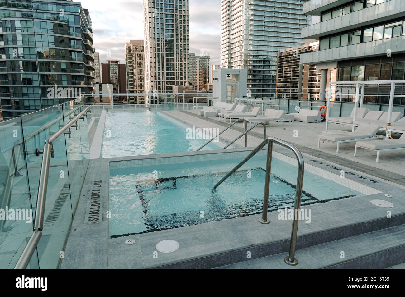 small empty swimming pool on the rooftop of a building overlooking ...