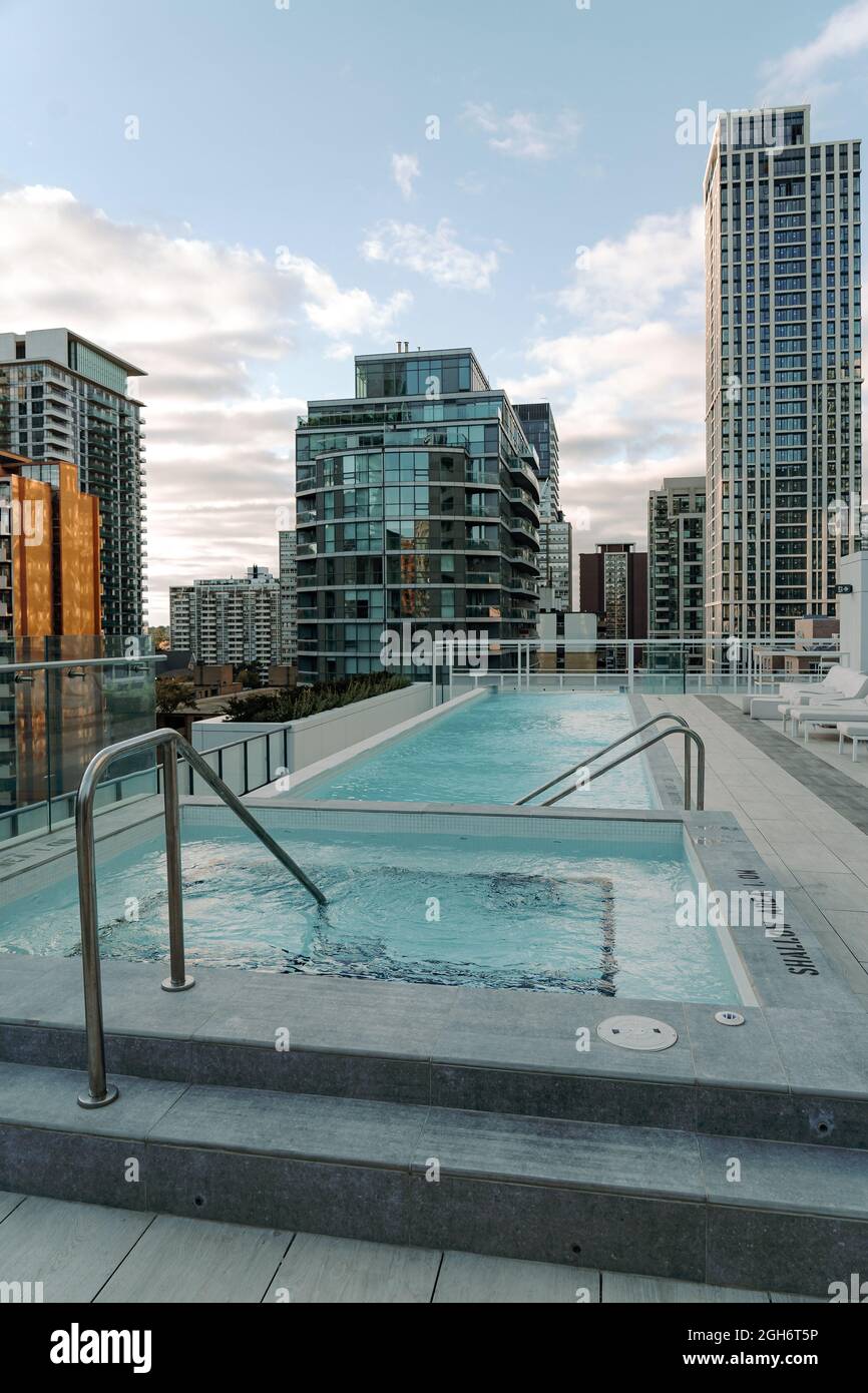 small empty swimming pool on the rooftop of a building overlooking ...