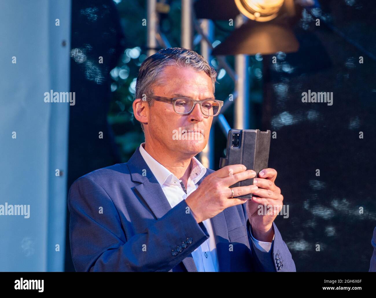 Essingen, Germany. 05th Sep, 2021. Candidate for the Bundestag Roderich Kiesewetter (CDU) takes pictures with his mobile phone at an election campaign event of the CDU Baden-Württemberg, which was also attended by CDU candidate for chancellor Laschet. Credit: Stefan Puchner/dpa/Alamy Live News Stock Photo