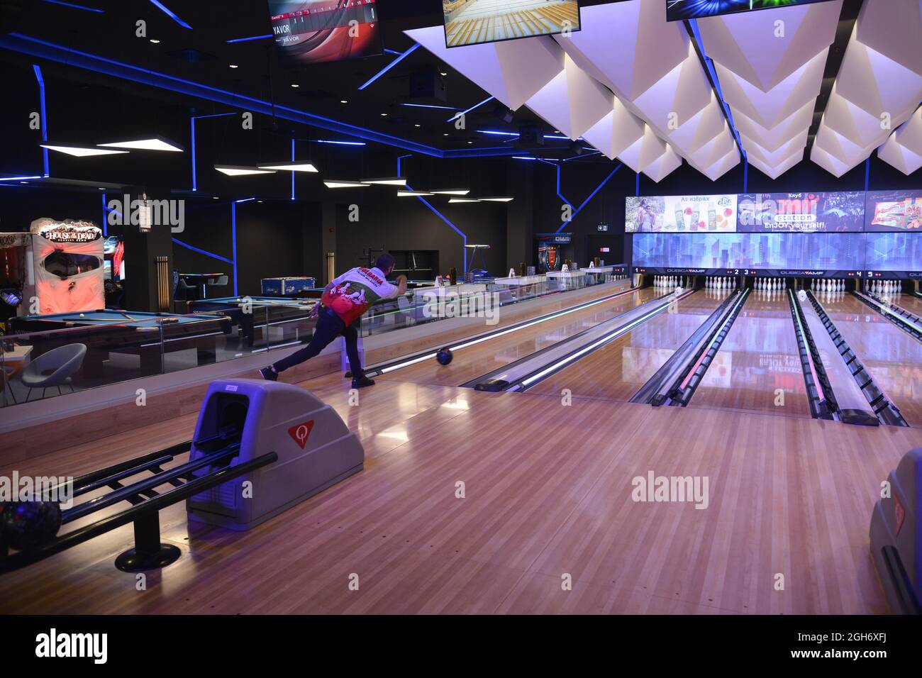 Sofia, Bulgaria - Aug 25 2021: A man watching his ball move on a bowling lane Stock Photo