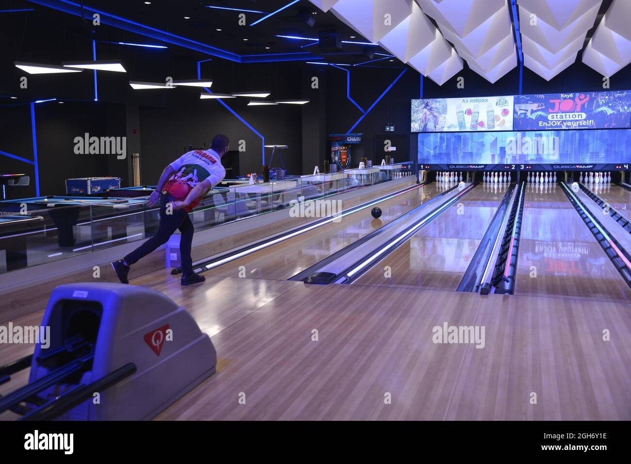 Sofia, Bulgaria - Aug 25 2021: A man watching his ball move on a bowling lane Stock Photo