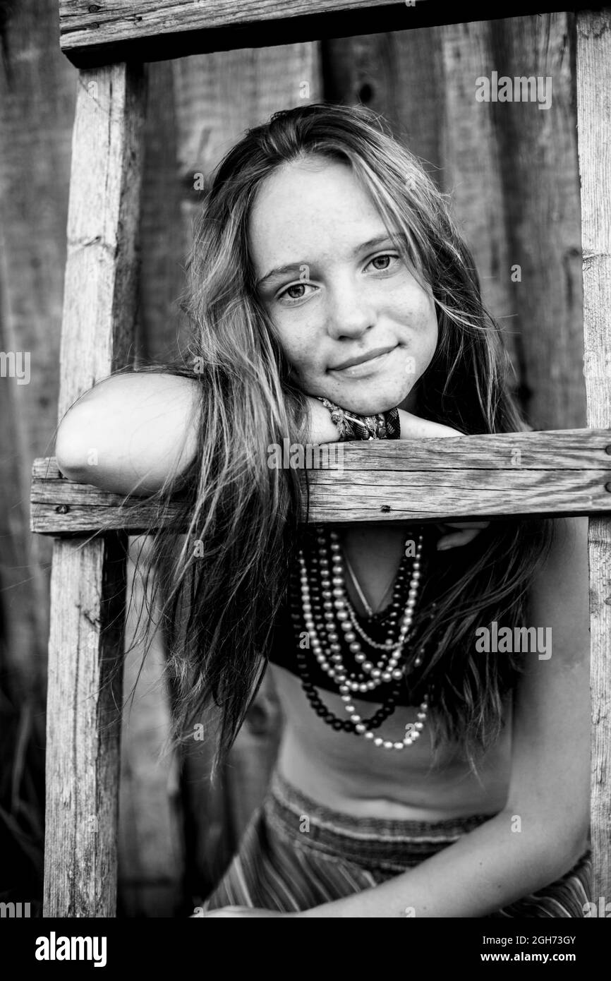 Girl with hippie jewelry in rural surroundings. Black and white photo. Stock Photo
