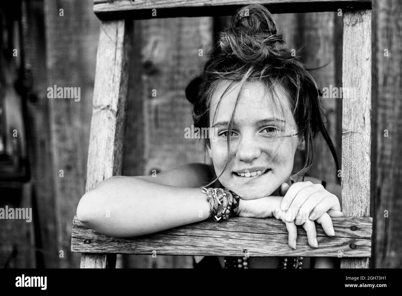Girl portrait with hippie jewelry in rural surroundings. Black and white photo. Stock Photo