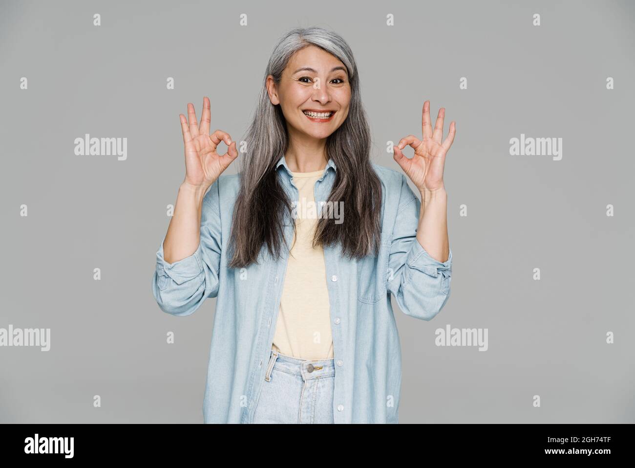 Mature woman showing sign hi-res stock photography and images - Alamy