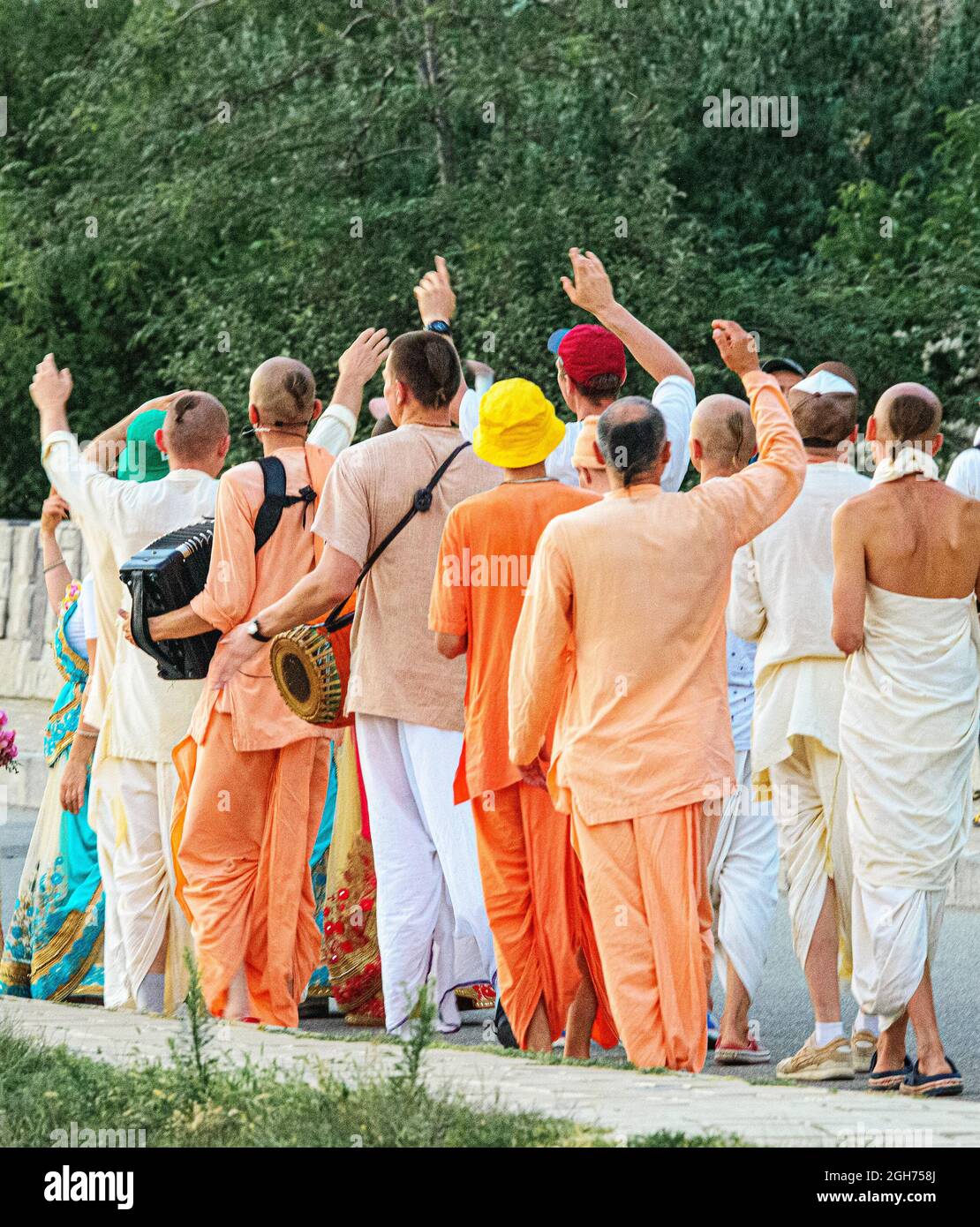 Hare Krishna singings march through the street Stock Photo