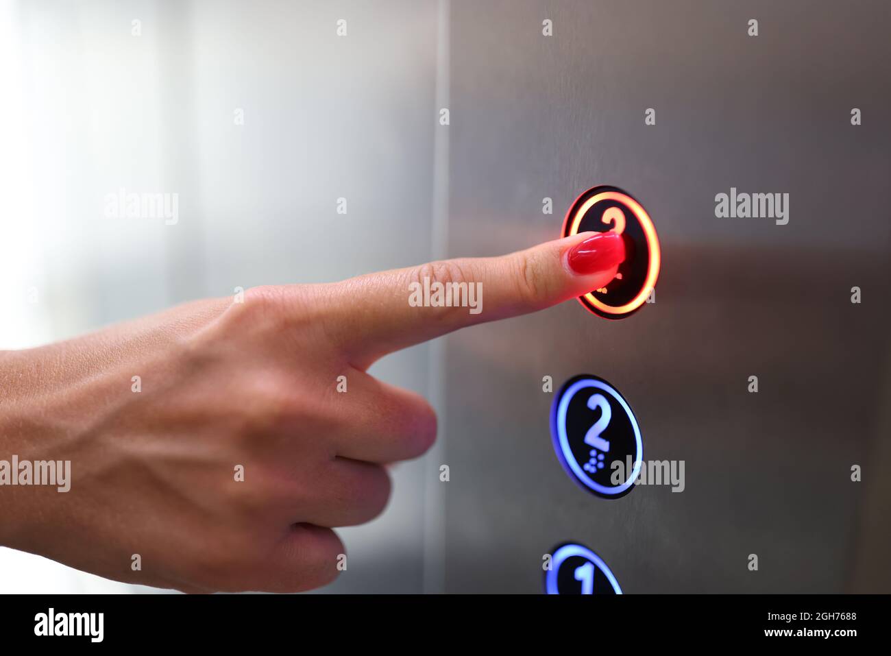Woman finger presses a button in elevator closeup Stock Photo - Alamy