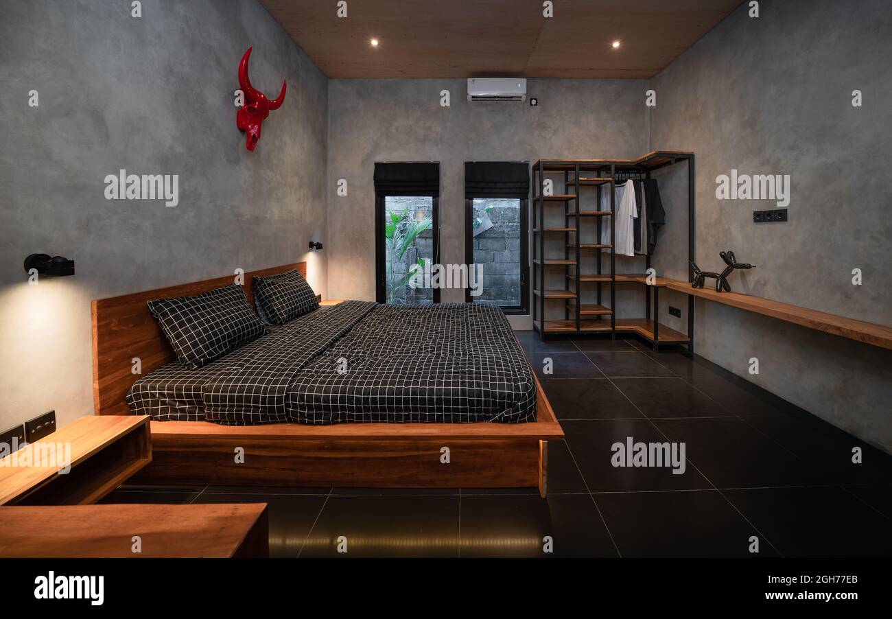 Luxury dark bedroom with modern wooden bed in loft style interior Luxury dark bedroom with modern wooden bed in loft style interior