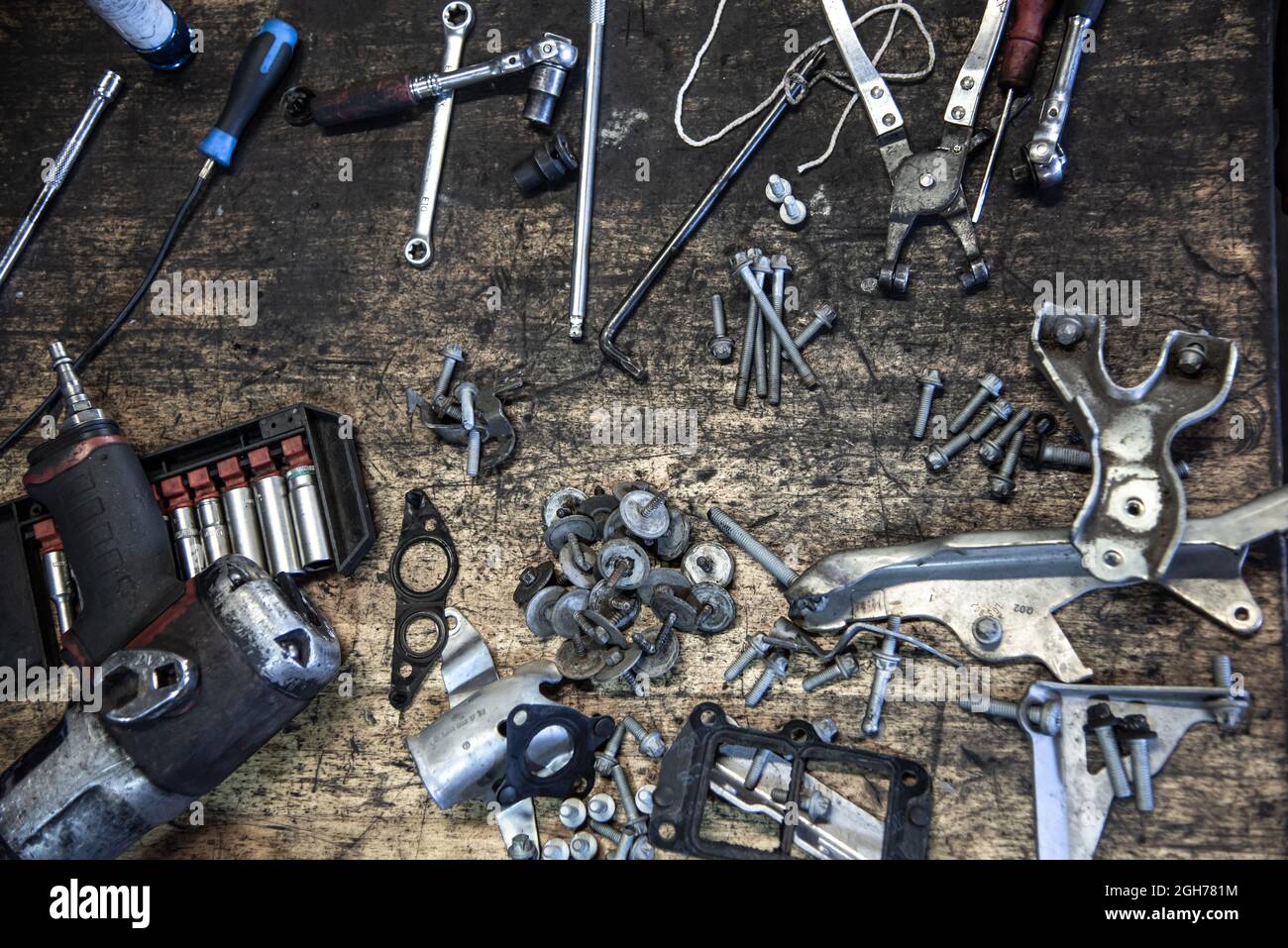 Bolts and nuts ready to go back into engine bay on car on a garage