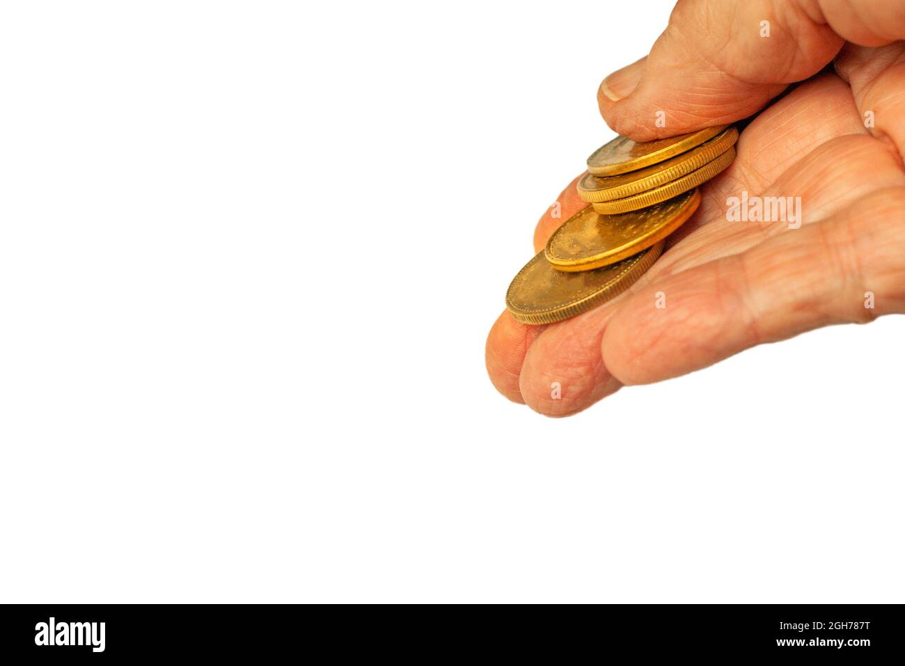 Gold crypto currency or blank yellow coins in fingers of mature hand isolated. A few coins are given, dropped , spent, saved or displayed. Stock Photo