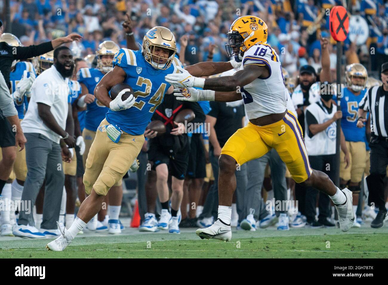 UCLA Bruins running back Zach Charbonnet (24) tries to escape LSU Tigers linebacker Damone Clark (18) during a NCAA football game against the LSU Tige Stock Photo