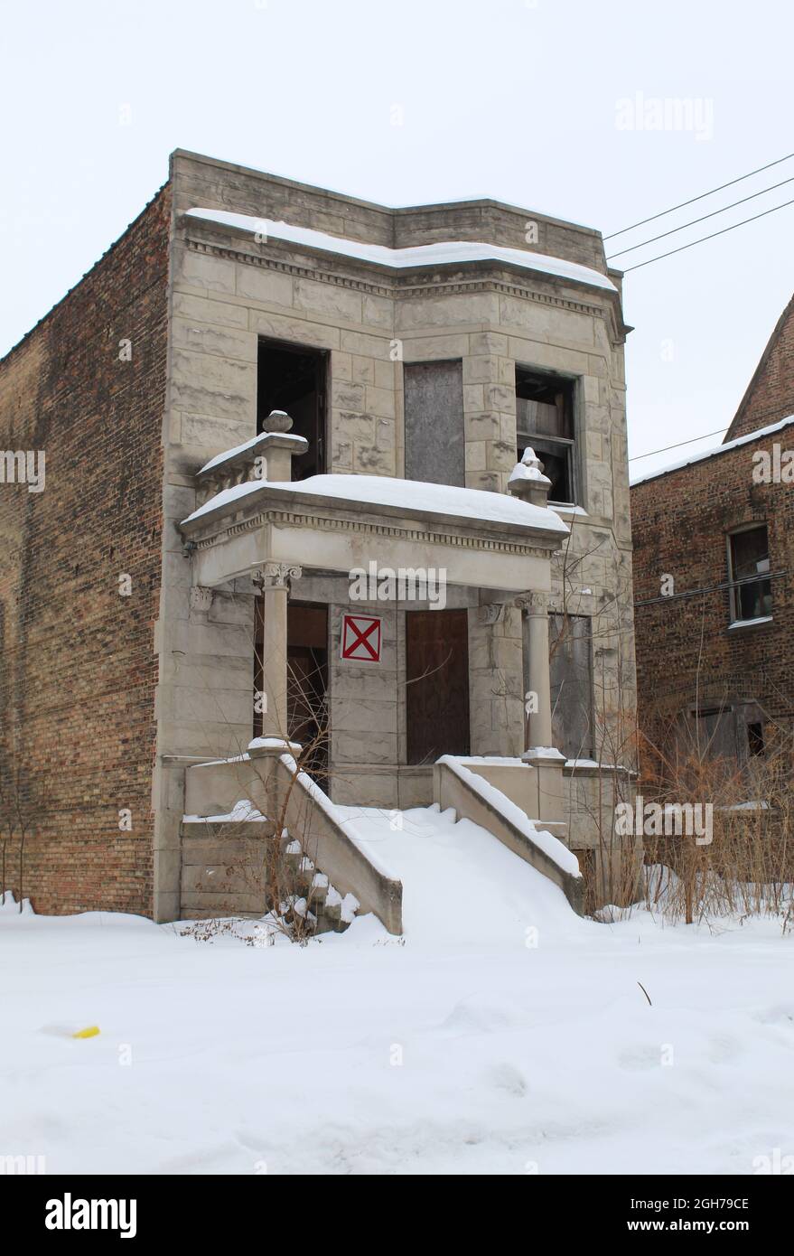 Abandoned Chicago greystone in snow in the Englewood neighborhood on the South Side Stock Photo