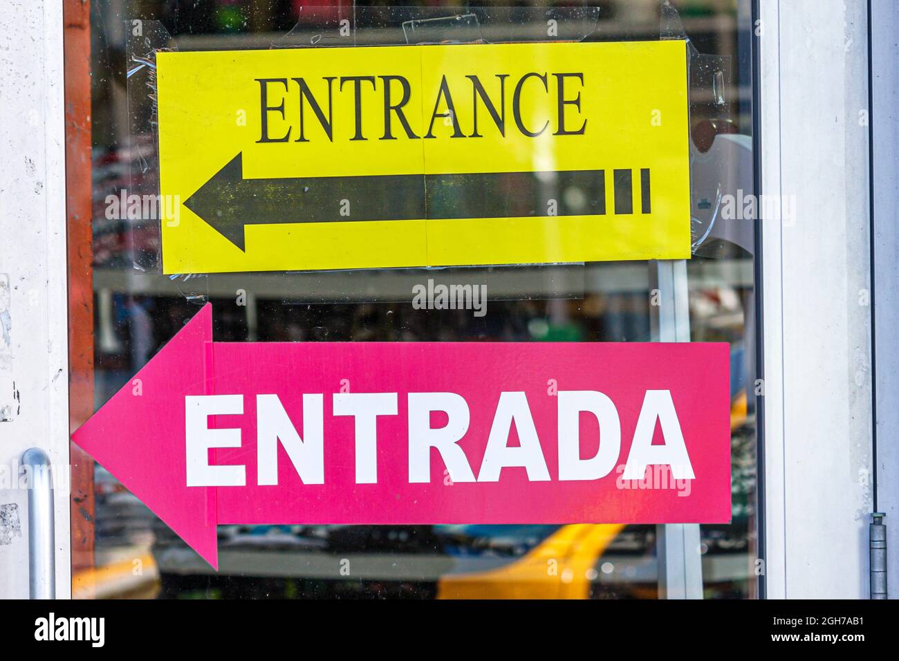 Miami Beach Florida,sign entrance entrada Spanish English language bilingual arrow directional Stock Photo