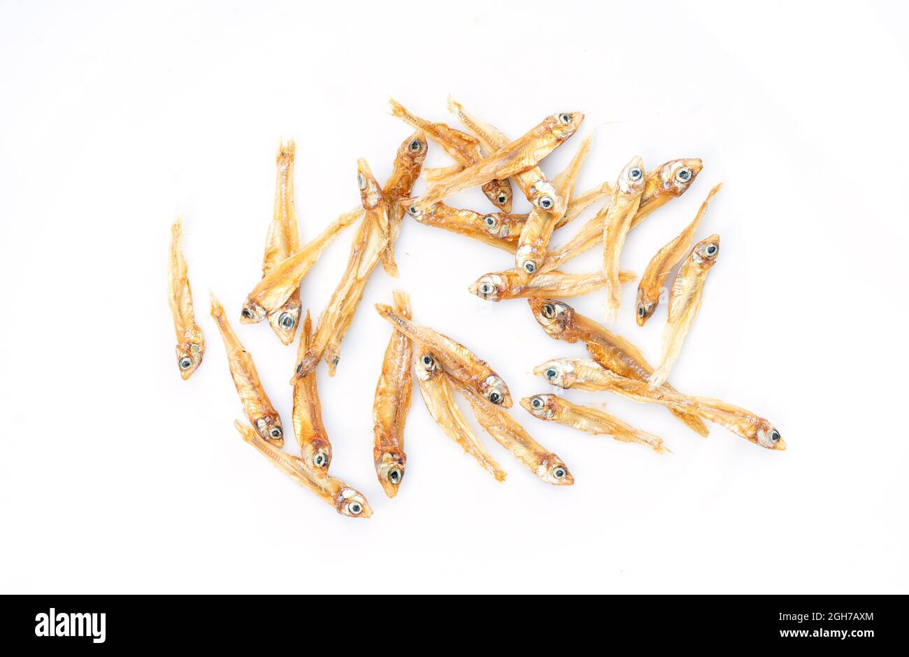 Dried anchovies fish on white background, macro image, isolated dried