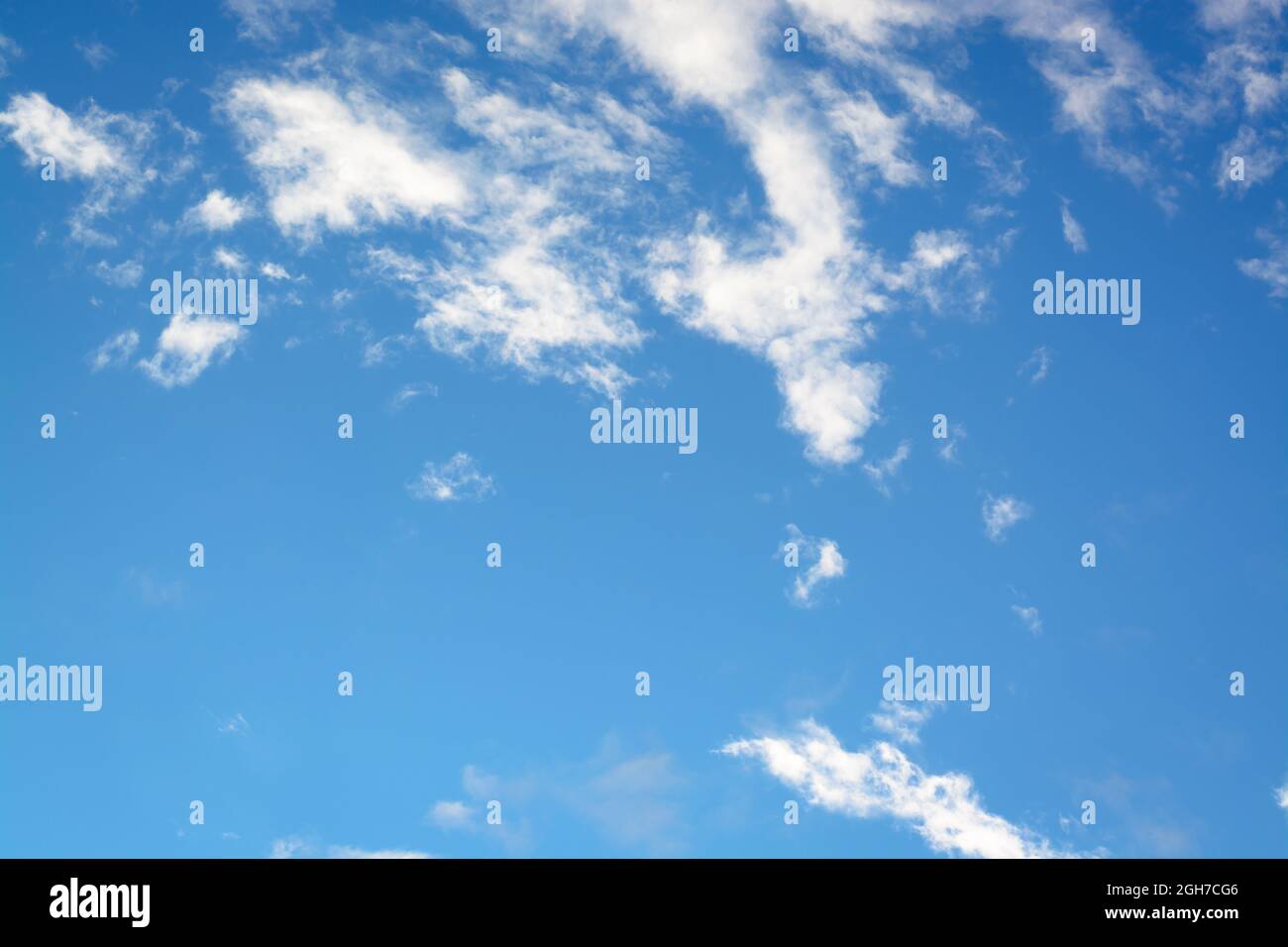 Horizontal view with white small clouds against blue sky Stock Photo
