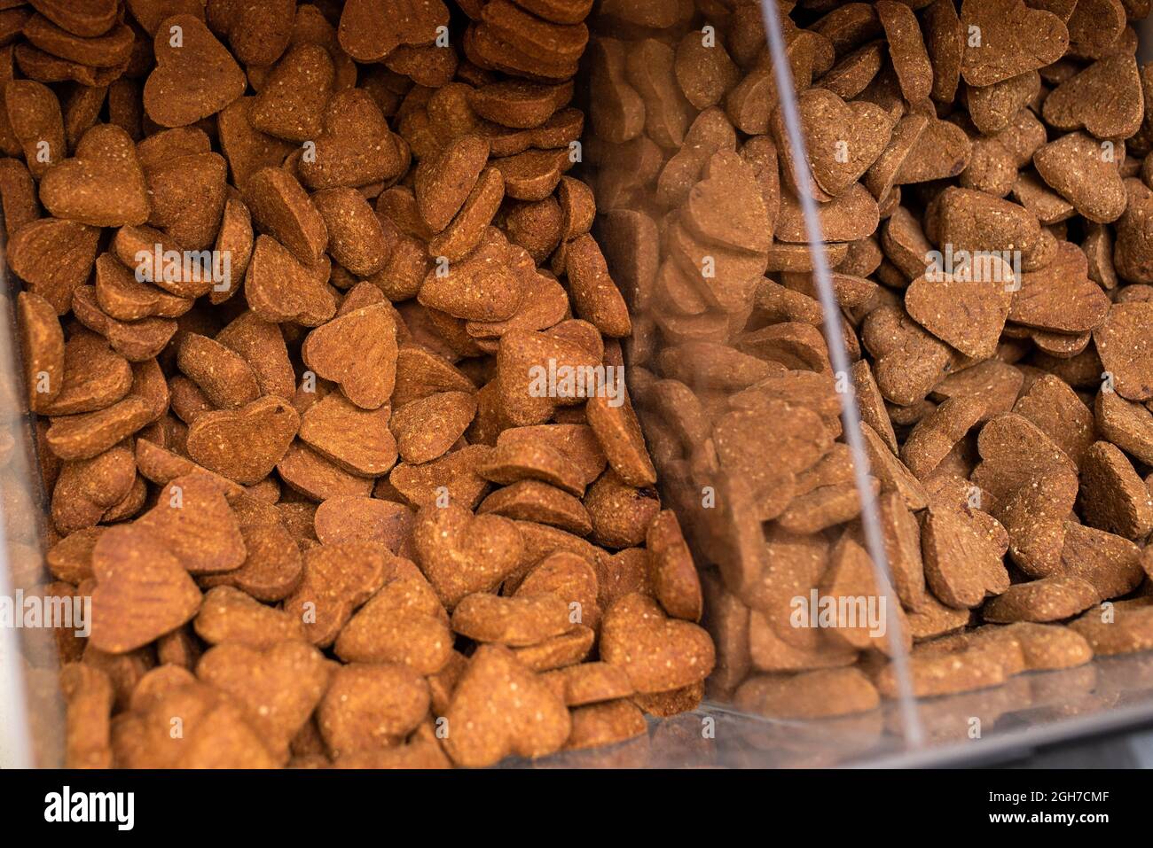 Bulk bin dog treats at a pet store. Bin full ofdog biscuit treats. Stock Photo