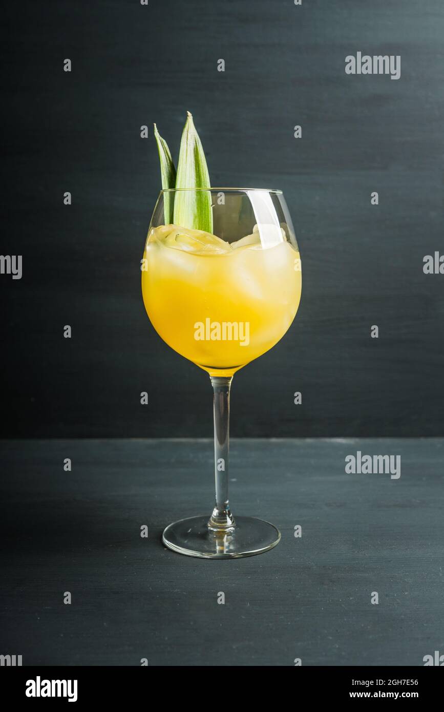 Pineapple cocktail in wine glass. Selective focus. Shallow depth of field  Stock Photo - Alamy