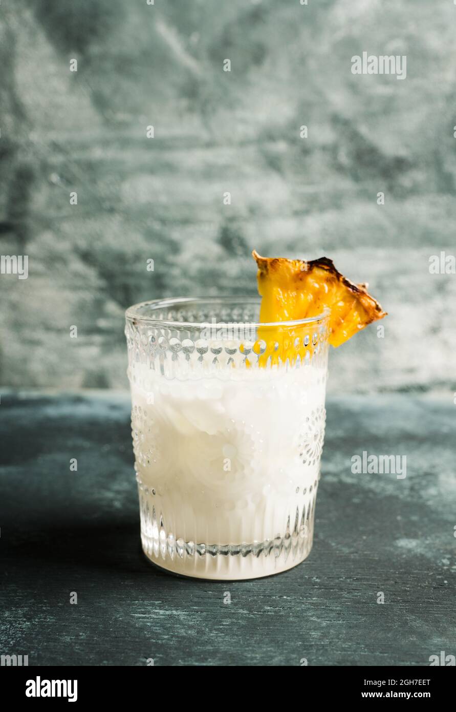 Pina colada cocktail on rustic background. Selective focus. Shallow depth of field. Stock Photo