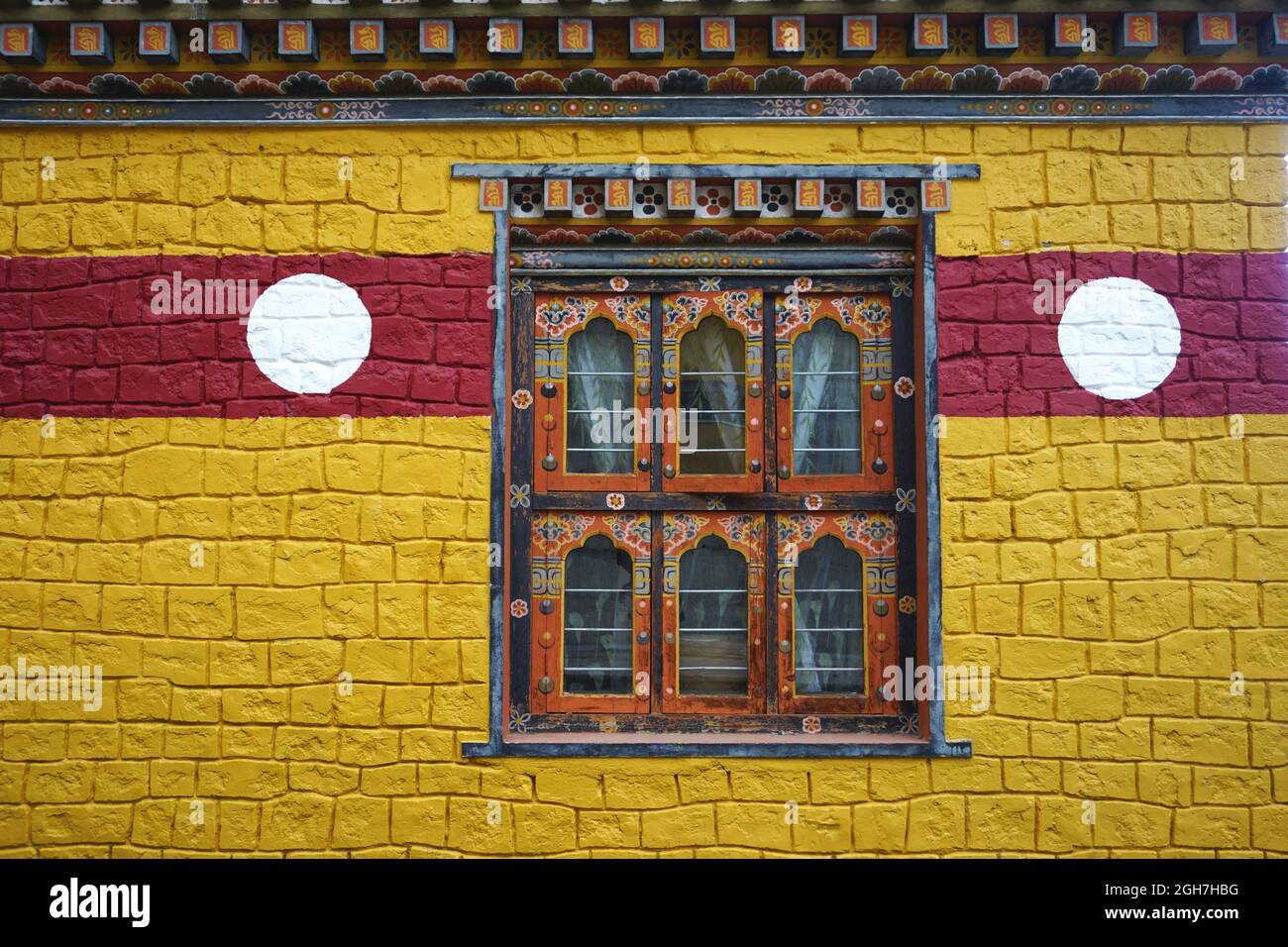 Colorful wall and window at Thangtong Dewachen Dupthop Nunnery, Thimphu, Bhutan. Intricately painted details are typical of Bhutanese architecture. Stock Photo