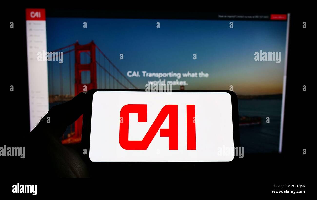 Cai Container Logo Person holding smartphone with logo of US logistics company CAI ...
