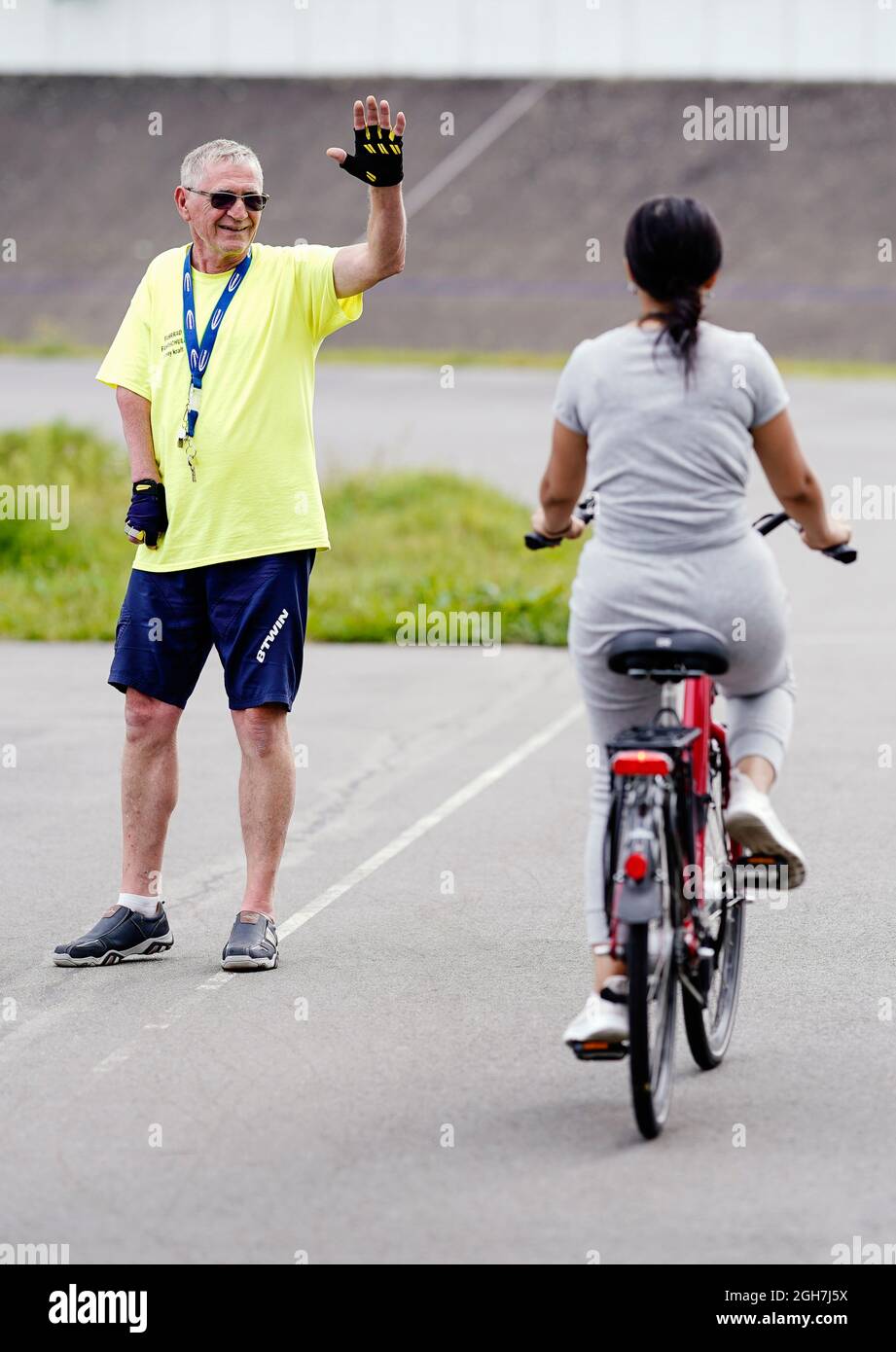 Mannheim, Germany. 26th Aug, 2021. Conny Kraft, driving instructor at the Rhine-Neckar Cycling School, signals Dounia to initiate a braking manoeuvre on the cycling track. Credit: Uwe Anspach/dpa/Alamy Live News Stock Photo