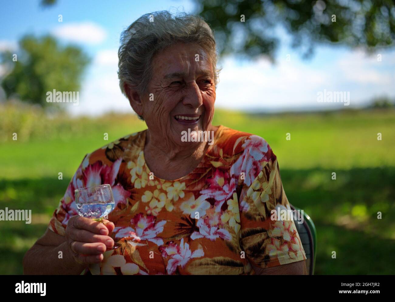 Old woman sitting alone in hi-res stock photography and images - Alamy