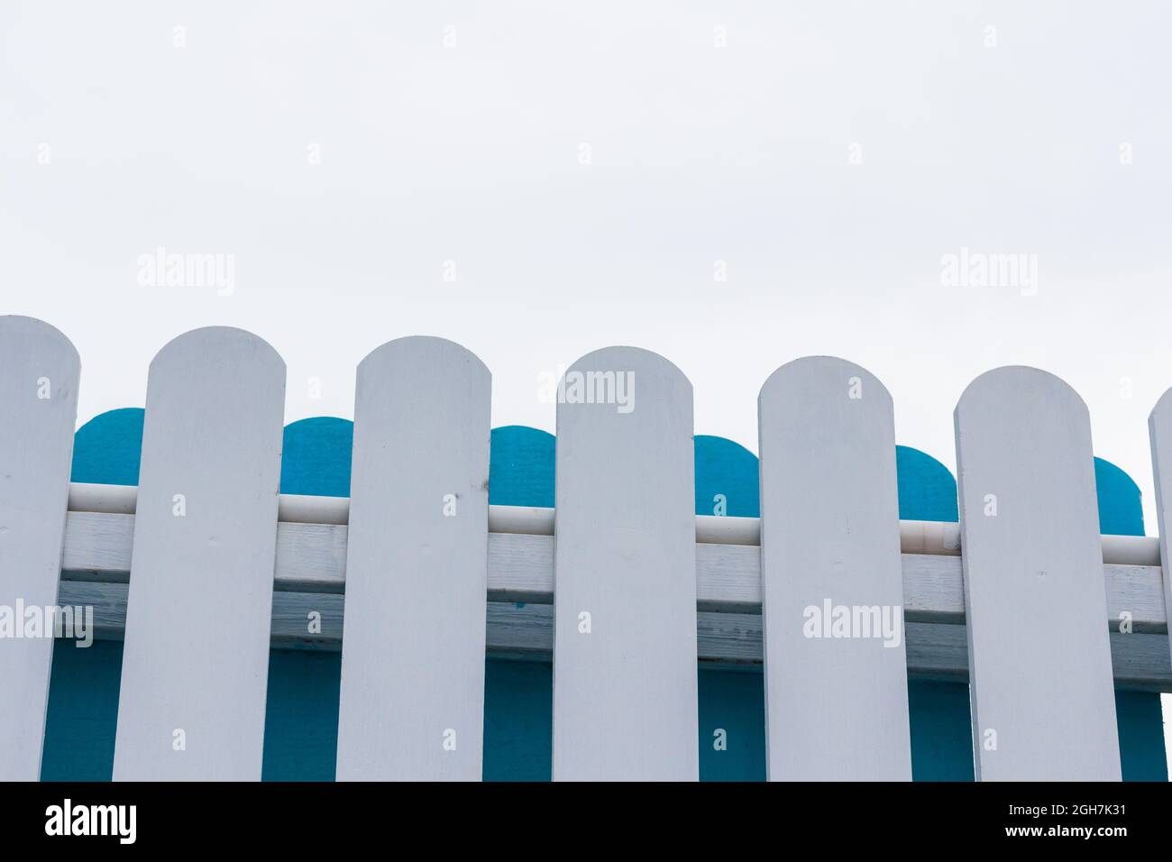 White and blue picket fence with sky background Stock Photo - Alamy