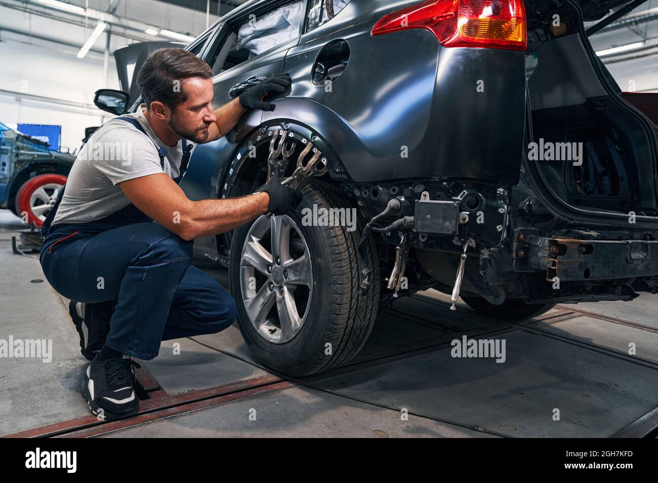 Two double clamps placed above car tire during repair Stock Photo