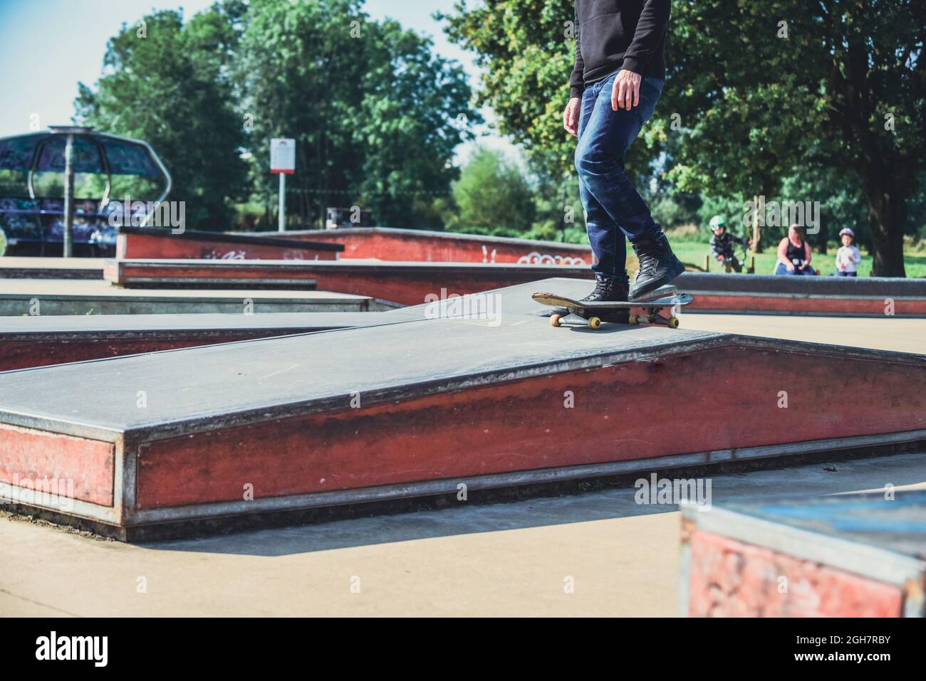 a skateboarder in action doing tricks on ramps at a skate park Stock ...