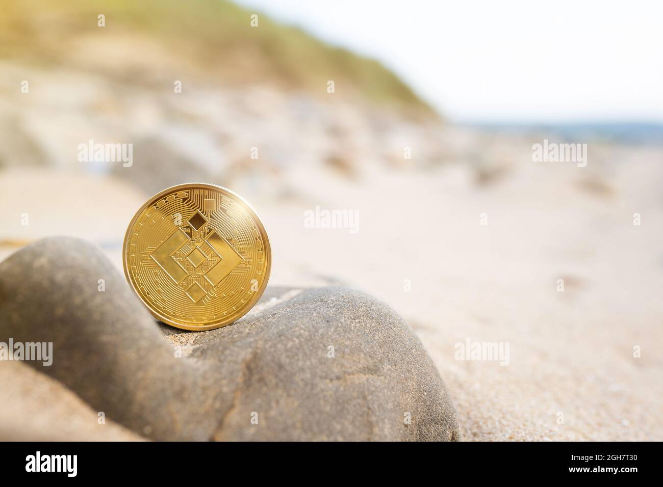 Binance coin on stone with beach background with copy space. Single golden  crypto BNB outdoor banner in warm tones. Environment impact of mining  cryptocurrency, Summer, vacation concept Stock Photo - Alamy