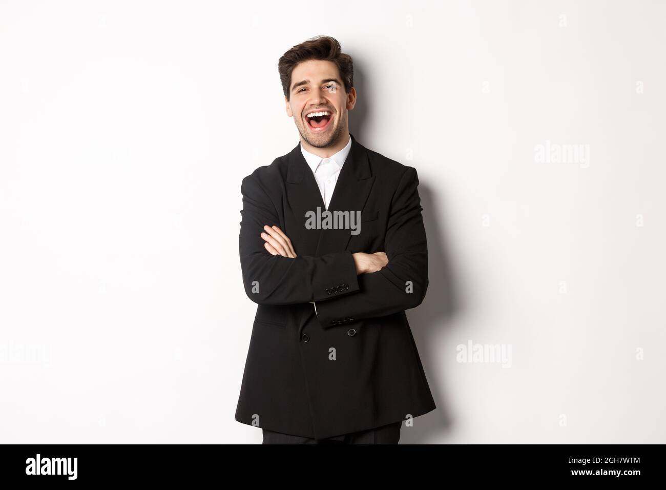 Portrait of attractive adult man in suit laughing and looking happy