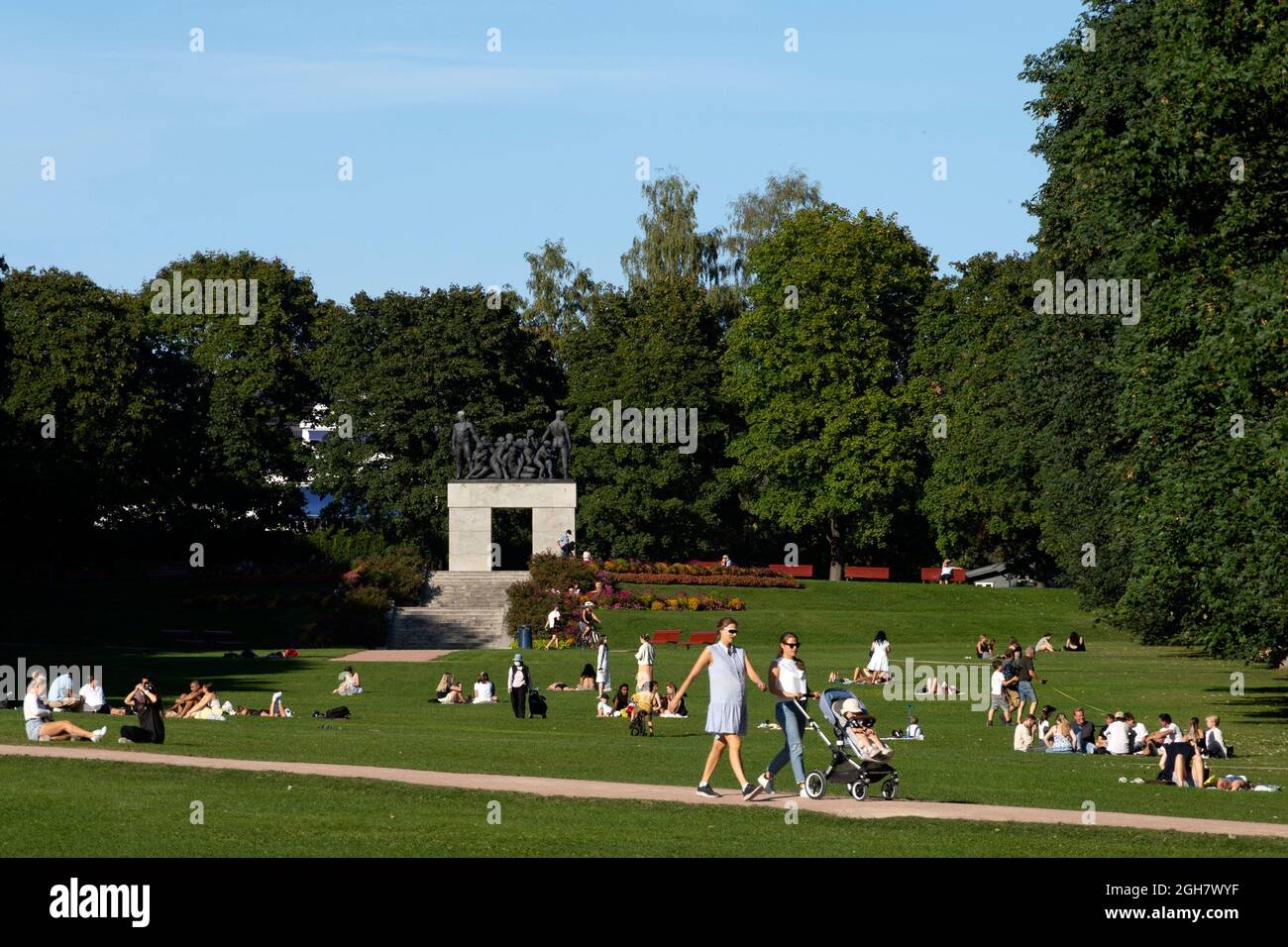 People enjoying the sun on an unusually hot day at the Frogner Park in Oslo, Norway Stock Photo