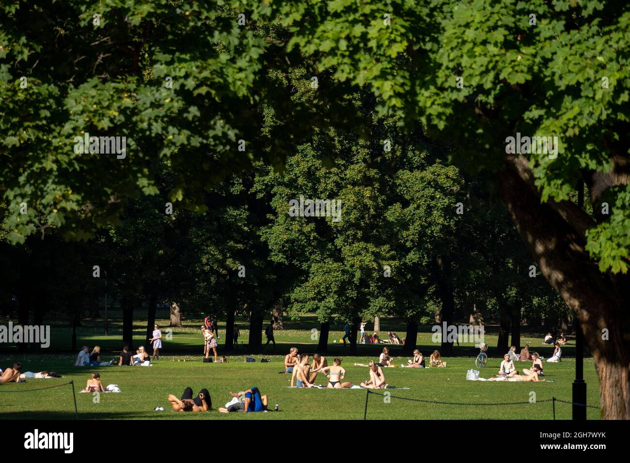 People enjoying the sun on an unusually hot day at the Frogner Park in Oslo, Norway Stock Photo