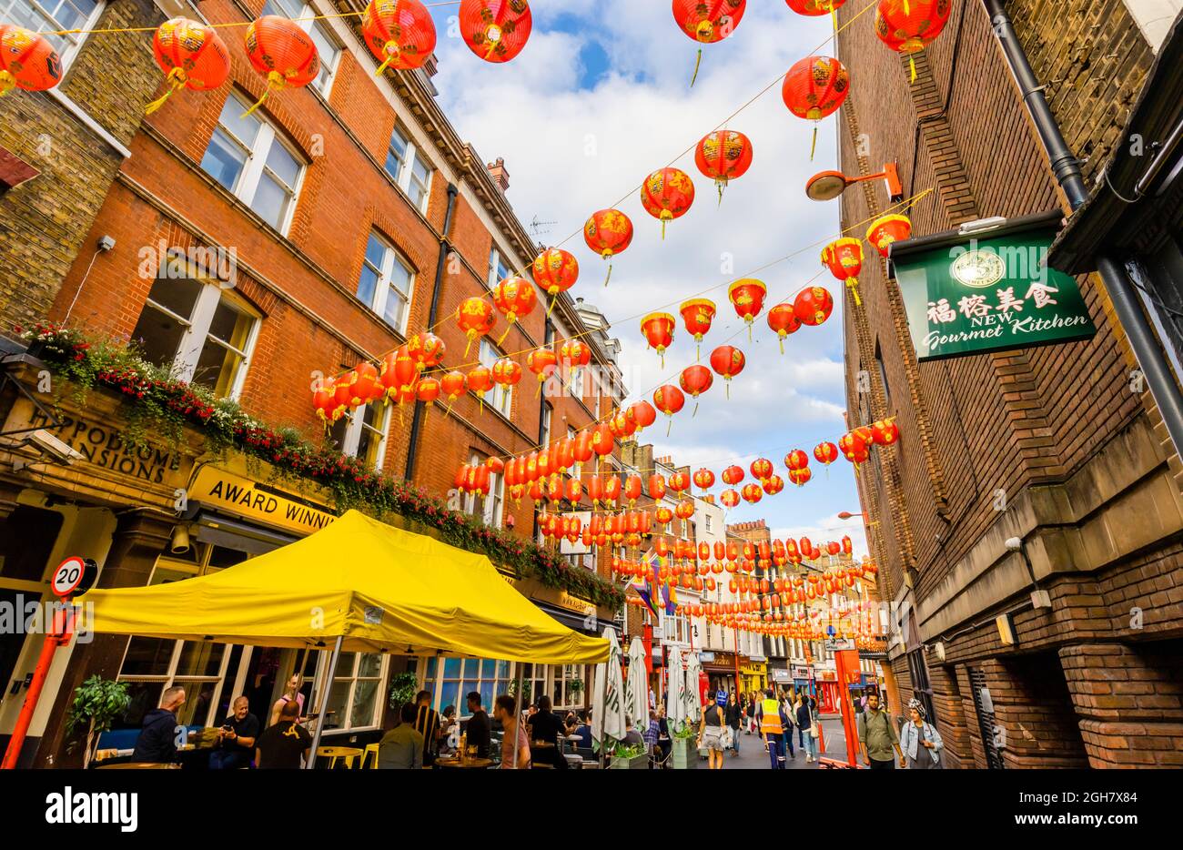 Colourful red and gold Chinese lanterns strung across Lisle Street in Chinatown in the West End of London, City of Westminster W1 district Stock Photo