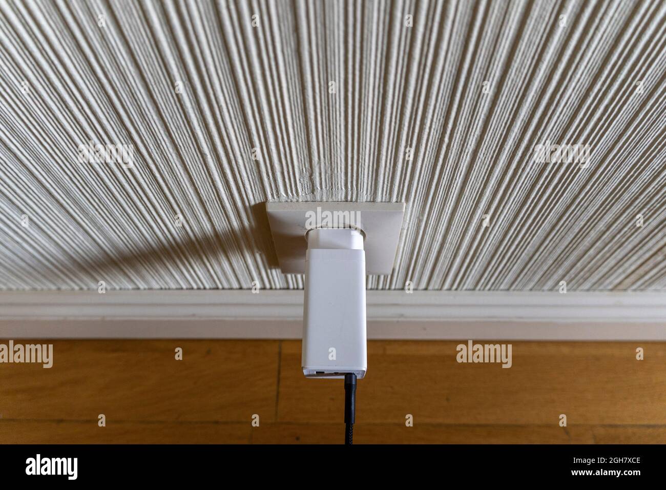 White USB phone charger plugged into a power outlet Stock Photo Alamy