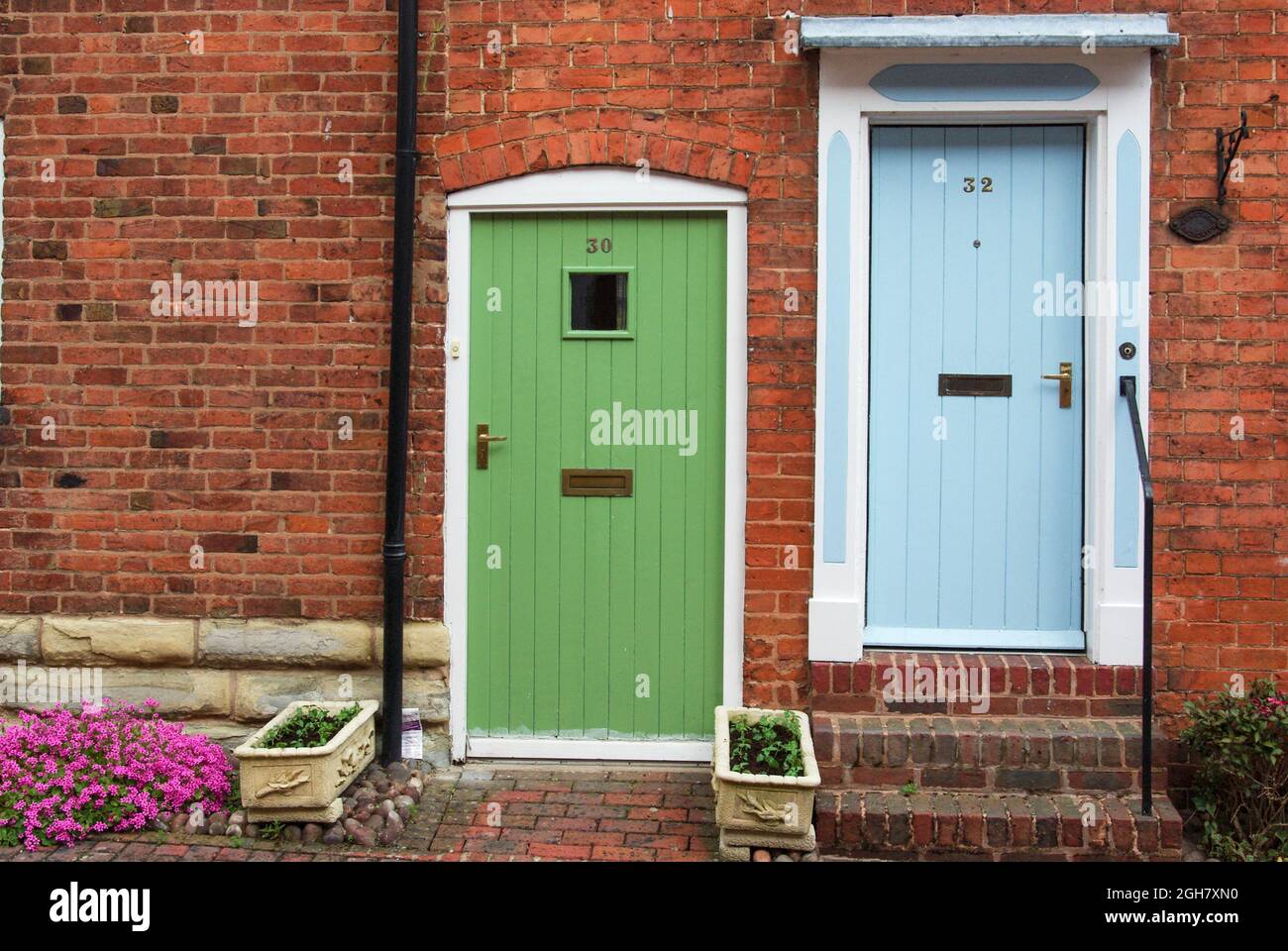 Colourful doors from halls adjoining housing in the market town of Alcester, Warwickshire, UK Stock Photo