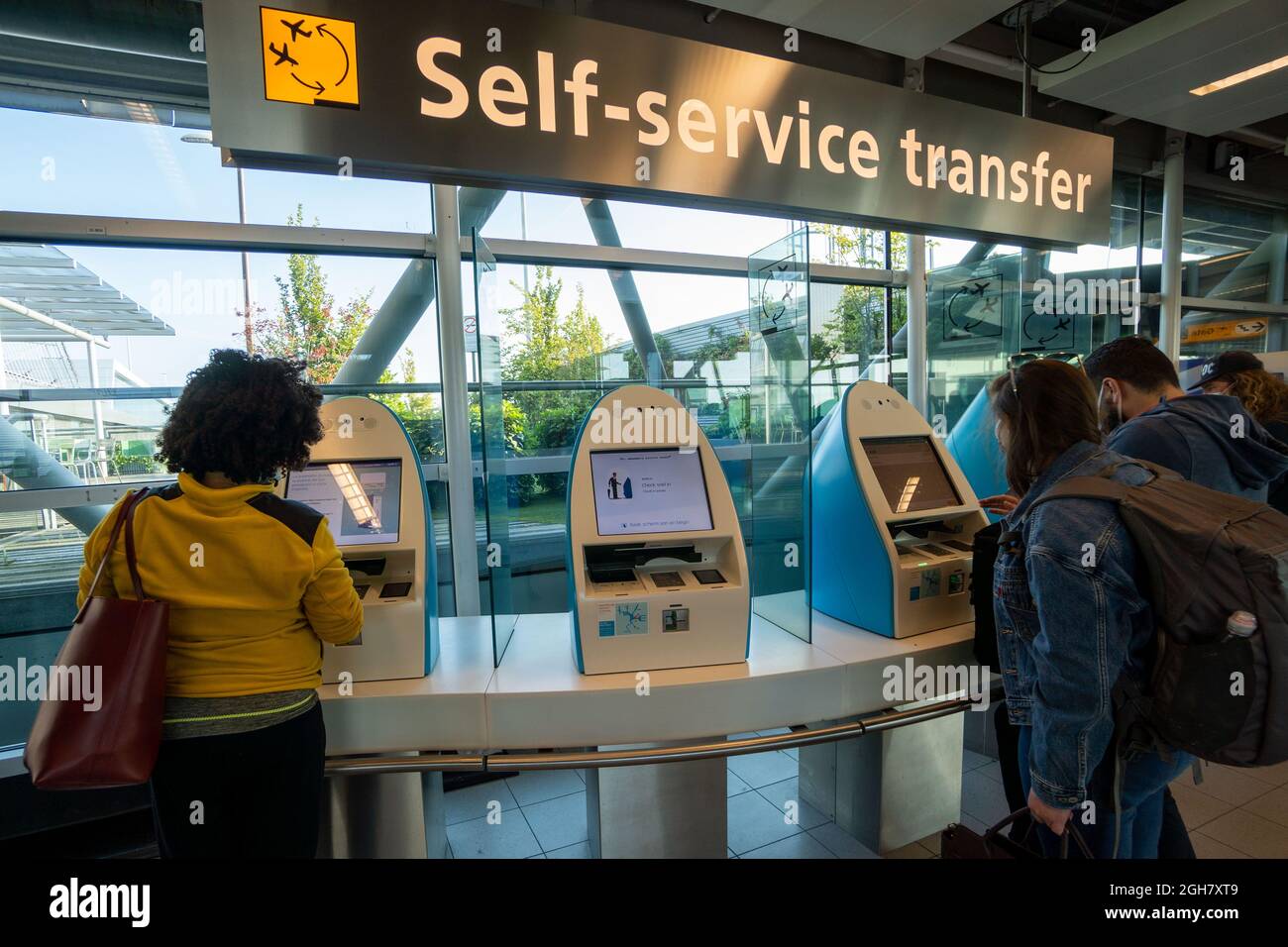 Passengers using the self-service transfer system at Schiphol Airport in Amsterdam, The Netherlands, Europe Stock Photo