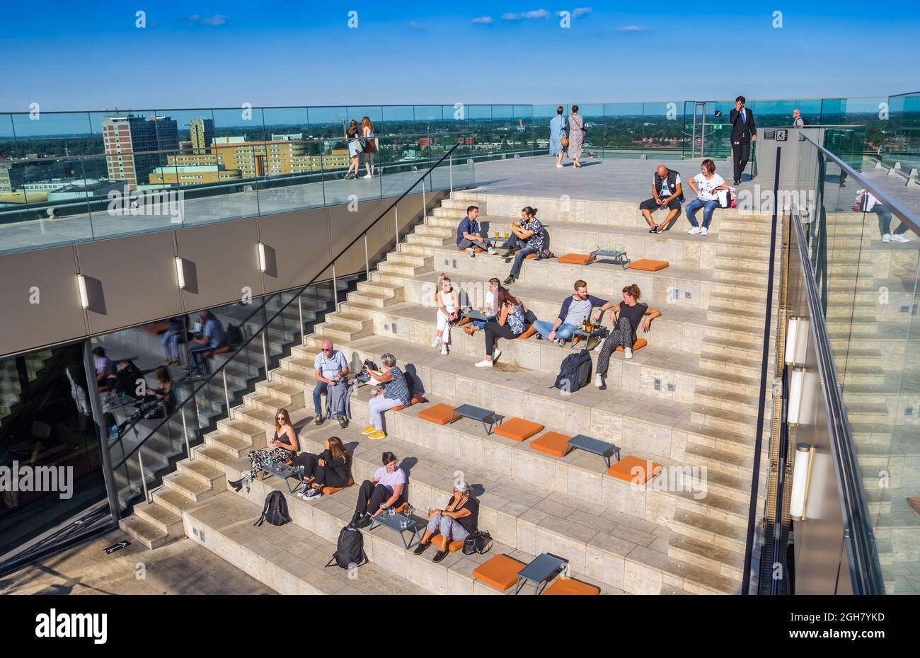 People enjoying the summer sun on top of the Forum building in Groningen, Netherlands Stock Photo