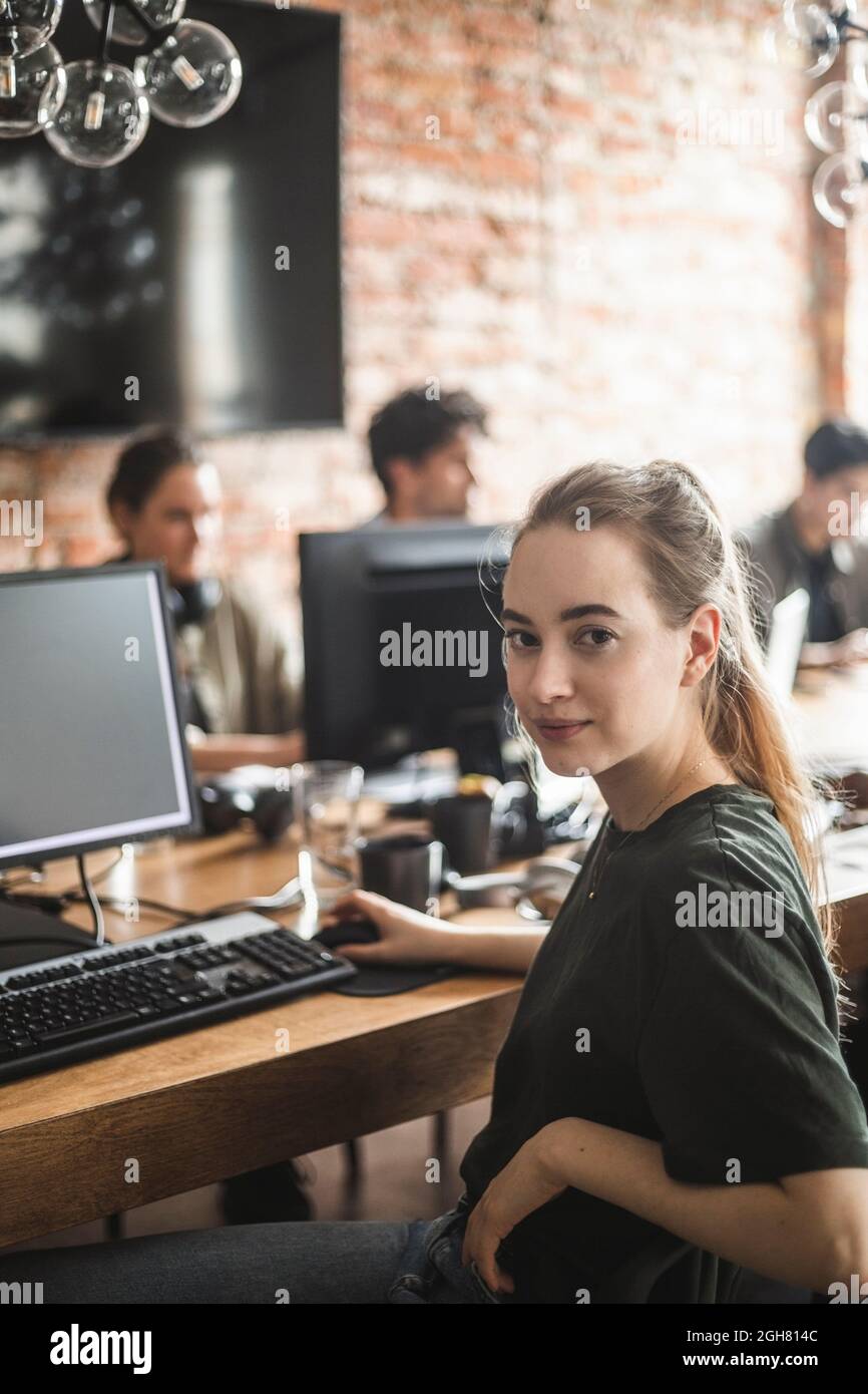 Portrait of female computer programmer at office Stock Photo - Alamy