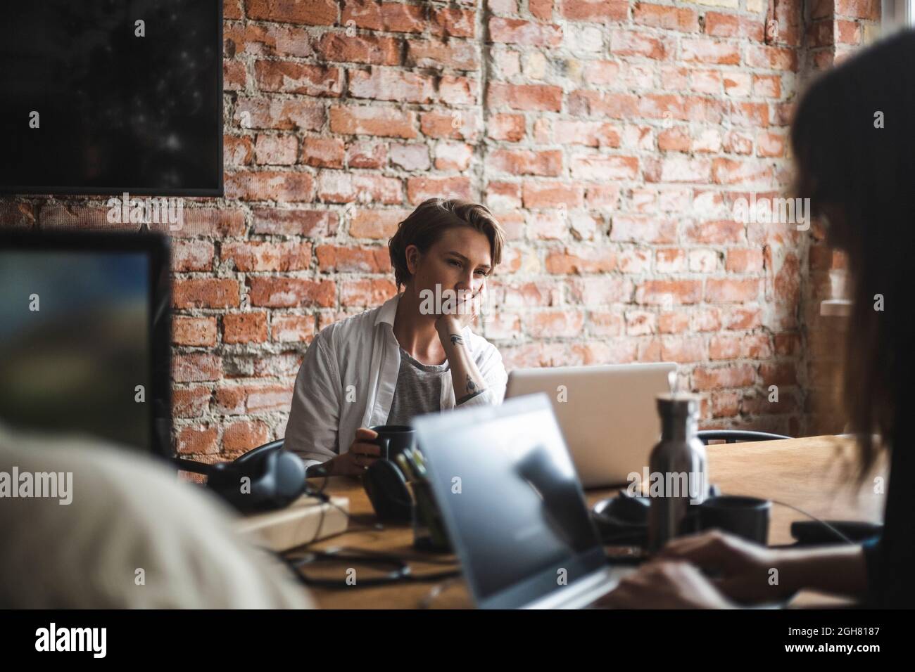 Female computer programmers working on laptop in startup company Stock Photo