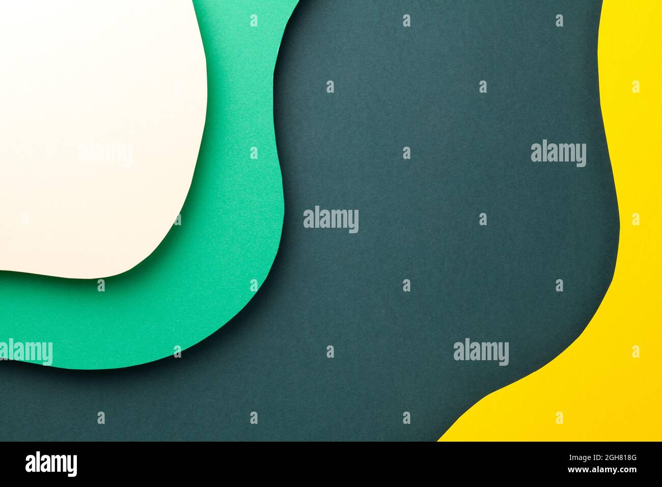 Paper background with various colored wavy layers. Empty room for text. Top view. Flat lay Stock Photo